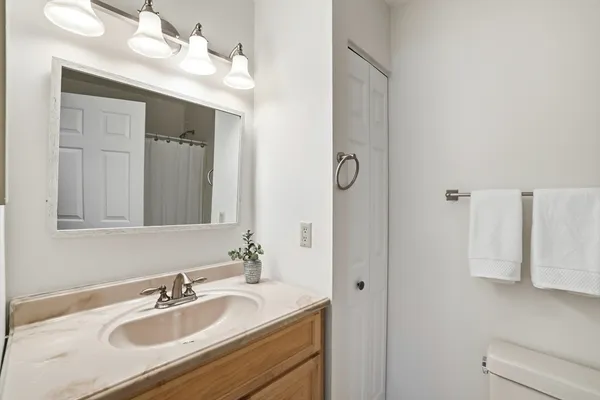 a bathroom with a sink vanity and mirror