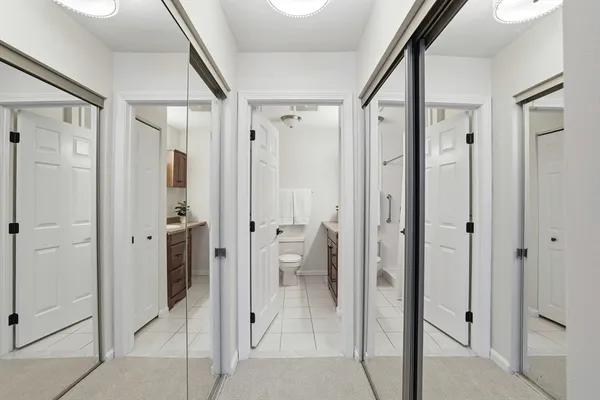 a bathroom with a glass shower door a bathtub a sink and a mirror