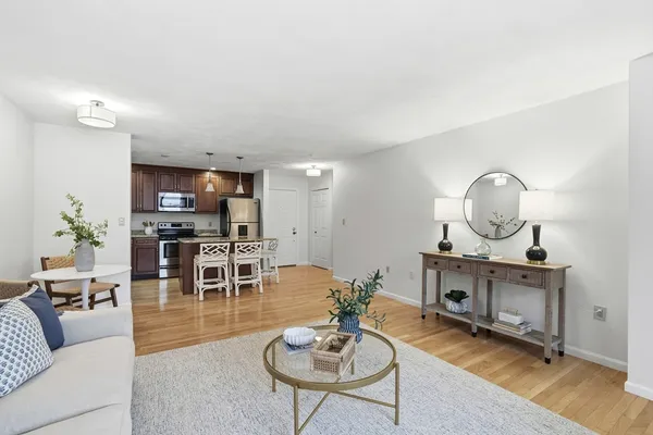 a living room with furniture a mirror and a table