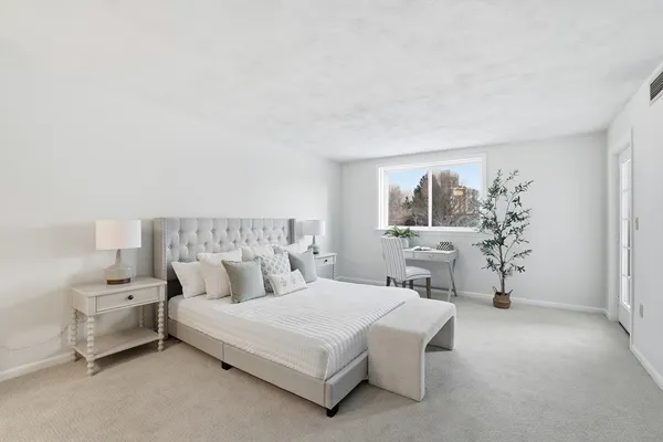 a bedroom with a bed and window