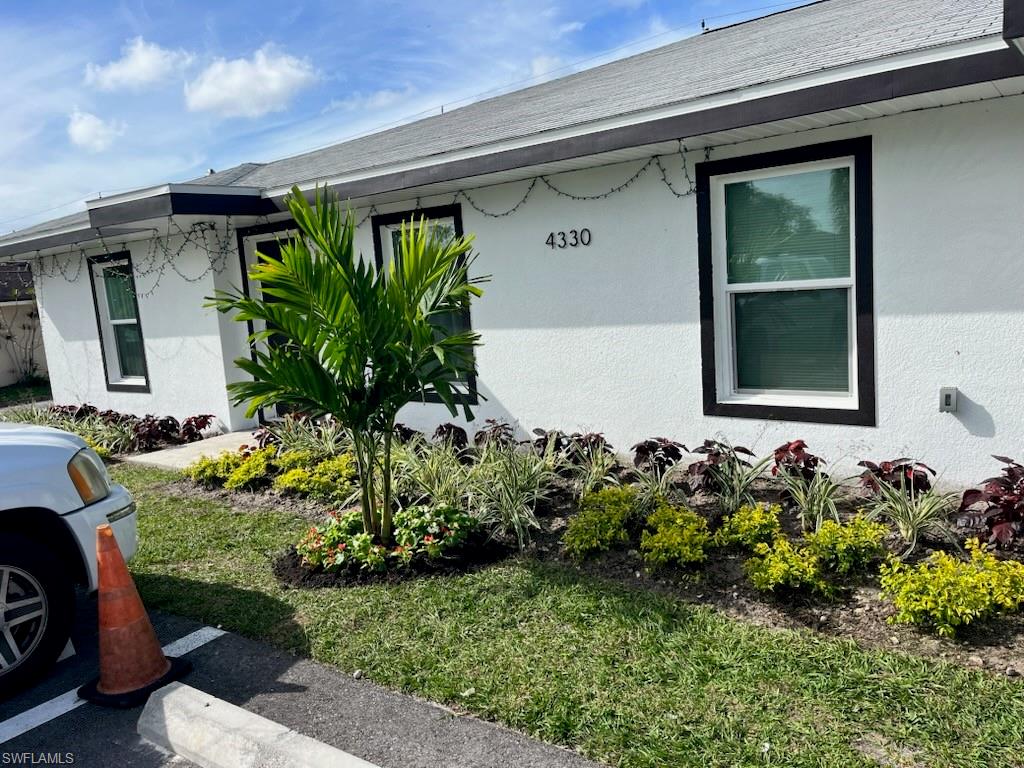 4330 Gulfstream Drive Naples, FL 34112 - Photo 2 of 15 a front view of a house with a yard