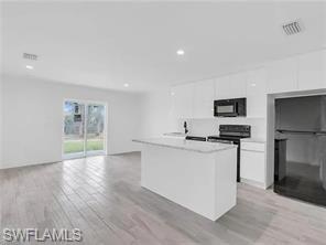 4330 Gulfstream Drive Naples, FL 34112 - Photo 3 of 15 a kitchen with stainless steel appliances a sink stove and refrigerator