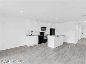 4330 Gulfstream Drive Naples, FL 34112 - Photo 4 of 15 a view of a kitchen with microwave and sink