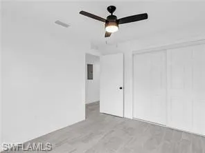 a view of a room with a ceiling fan