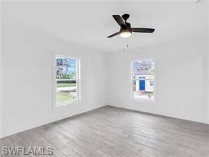 4330 Gulfstream Drive Naples, FL 34112 - Photo 6 of 15 an empty room with windows and ceiling fan