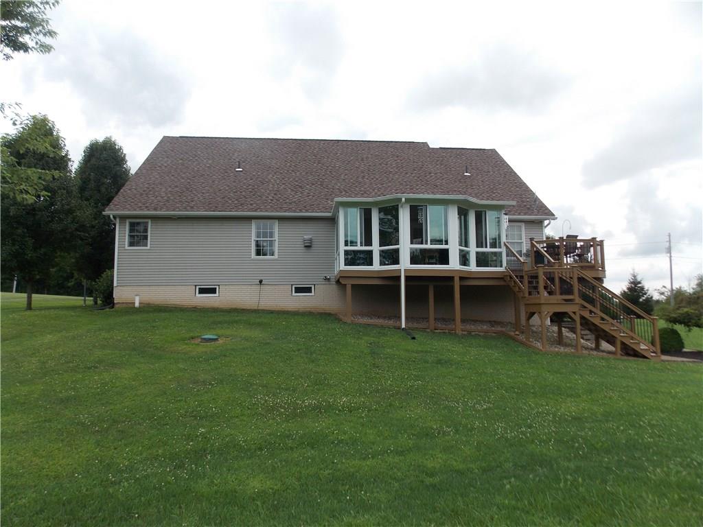 248 Buffalo Road South Washington, PA 15301 - Photo 4 of 20 View from the rear includes the enclosed sunroom and side deck with stairs to the above ground pool and lower level patio.