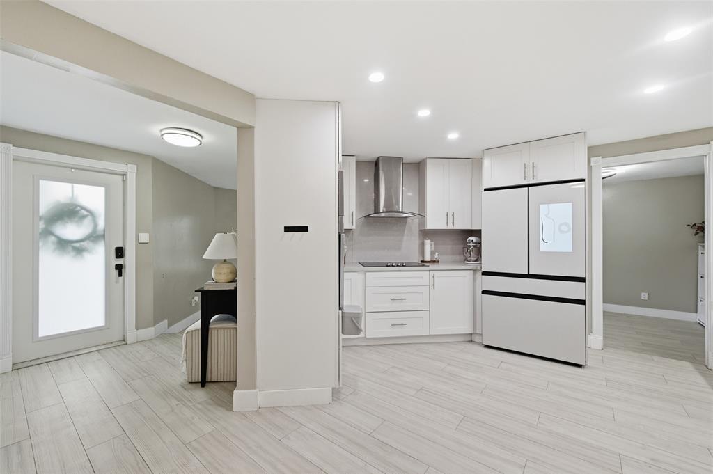 8340 Southwest 27th Place Davie, FL 33328 - Photo 11 of 25 a kitchen with white cabinets and stainless steel appliances