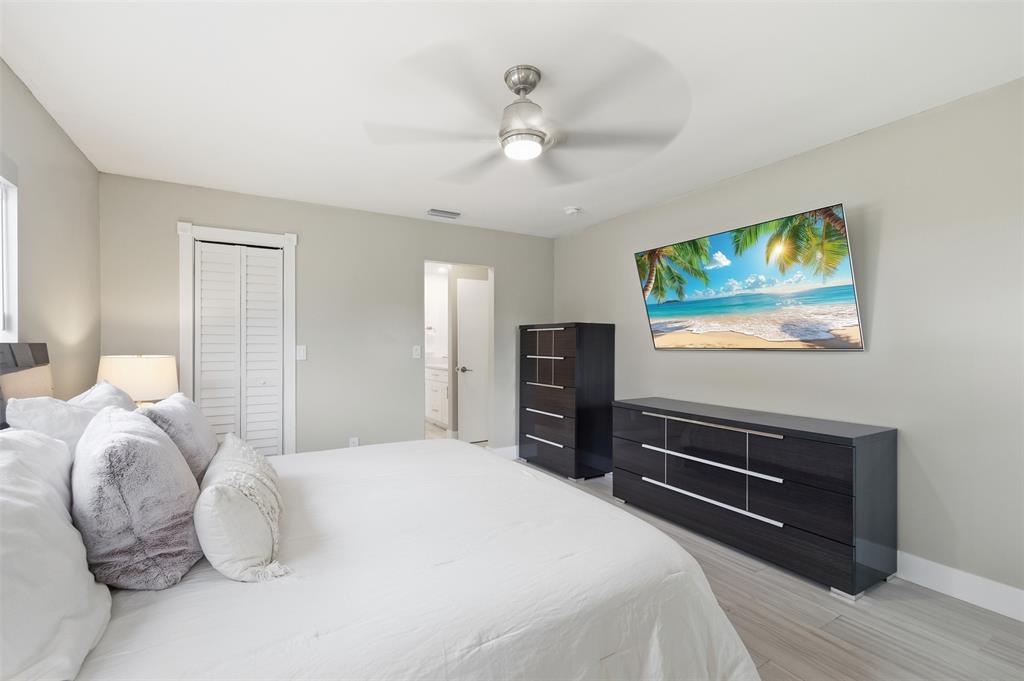 8340 Southwest 27th Place Davie, FL 33328 - Photo 12 of 25 a bedroom with a bed and a chandelier