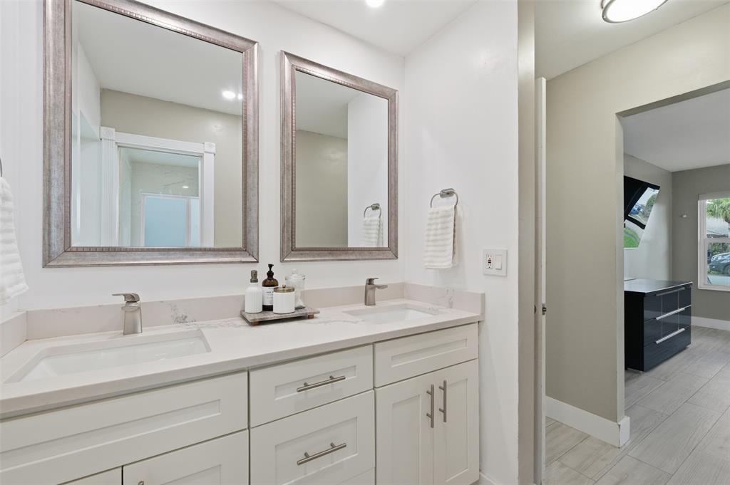 8340 Southwest 27th Place Davie, FL 33328 - Photo 14 of 25 a bathroom with double vanity sinks and a mirror
