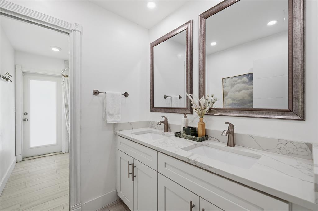 8340 Southwest 27th Place Davie, FL 33328 - Photo 17 of 25 a bathroom with double vanity sinks and a mirror