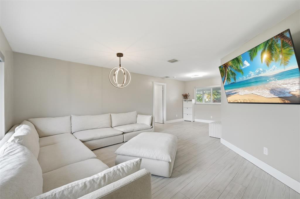 8340 Southwest 27th Place Davie, FL 33328 - Photo 4 of 25 a living room with furniture and a flat screen tv