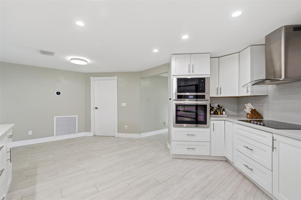 8340 Southwest 27th Place Davie, FL 33328 - Photo 8 of 25 a kitchen with granite countertop white cabinets and stainless steel appliances