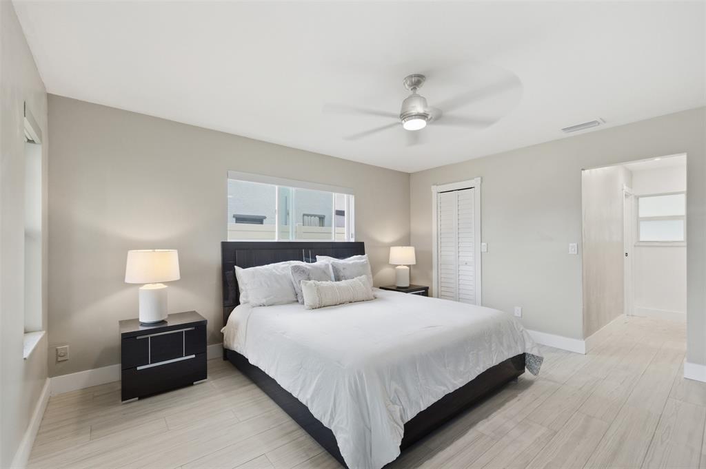 8340 Southwest 27th Place Davie, FL 33328 - Photo 9 of 25 a bedroom with a bed and a chandelier