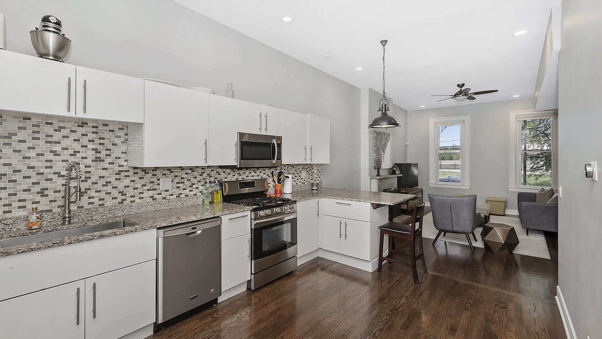 2339 West Maypole Avenue Chicago, IL 60612 - Photo 6 of 20 a kitchen with granite countertop a sink cabinets and stainless steel appliances