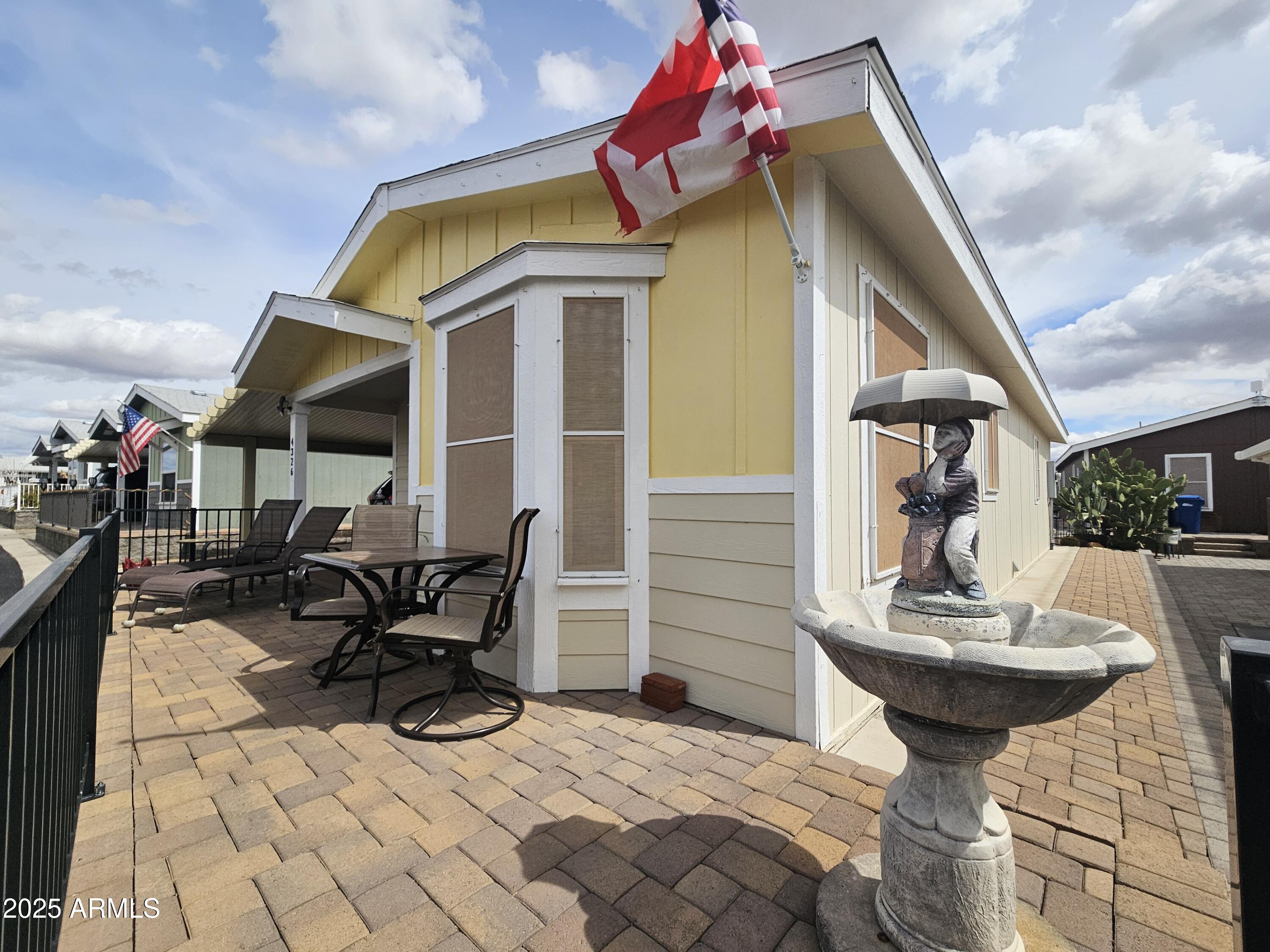 650 North Hawes Road, Unit 4326 Mesa, AZ 85207 - Photo 11 of 48 a view of a dinning tables and chairs in patio