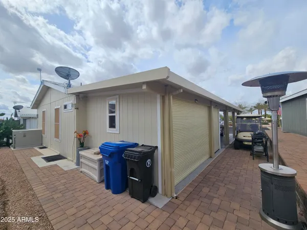 a kitchen with stainless steel appliances granite countertop a stove a refrigerator a kitchen island a dining table and chairs with wooden floor