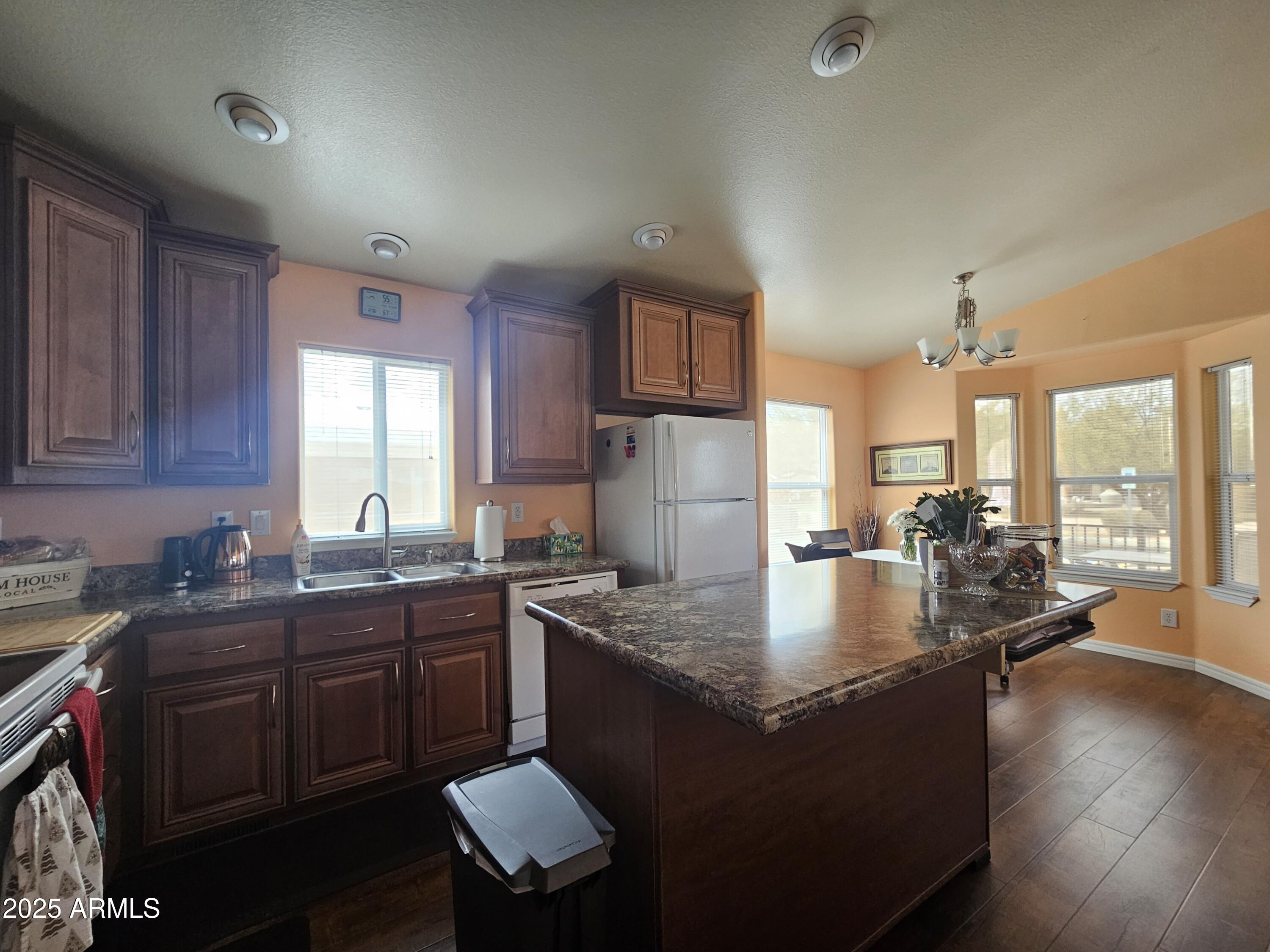 650 North Hawes Road, Unit 4326 Mesa, AZ 85207 - Photo 16 of 48 a kitchen with sink a refrigerator and wooden cabinets