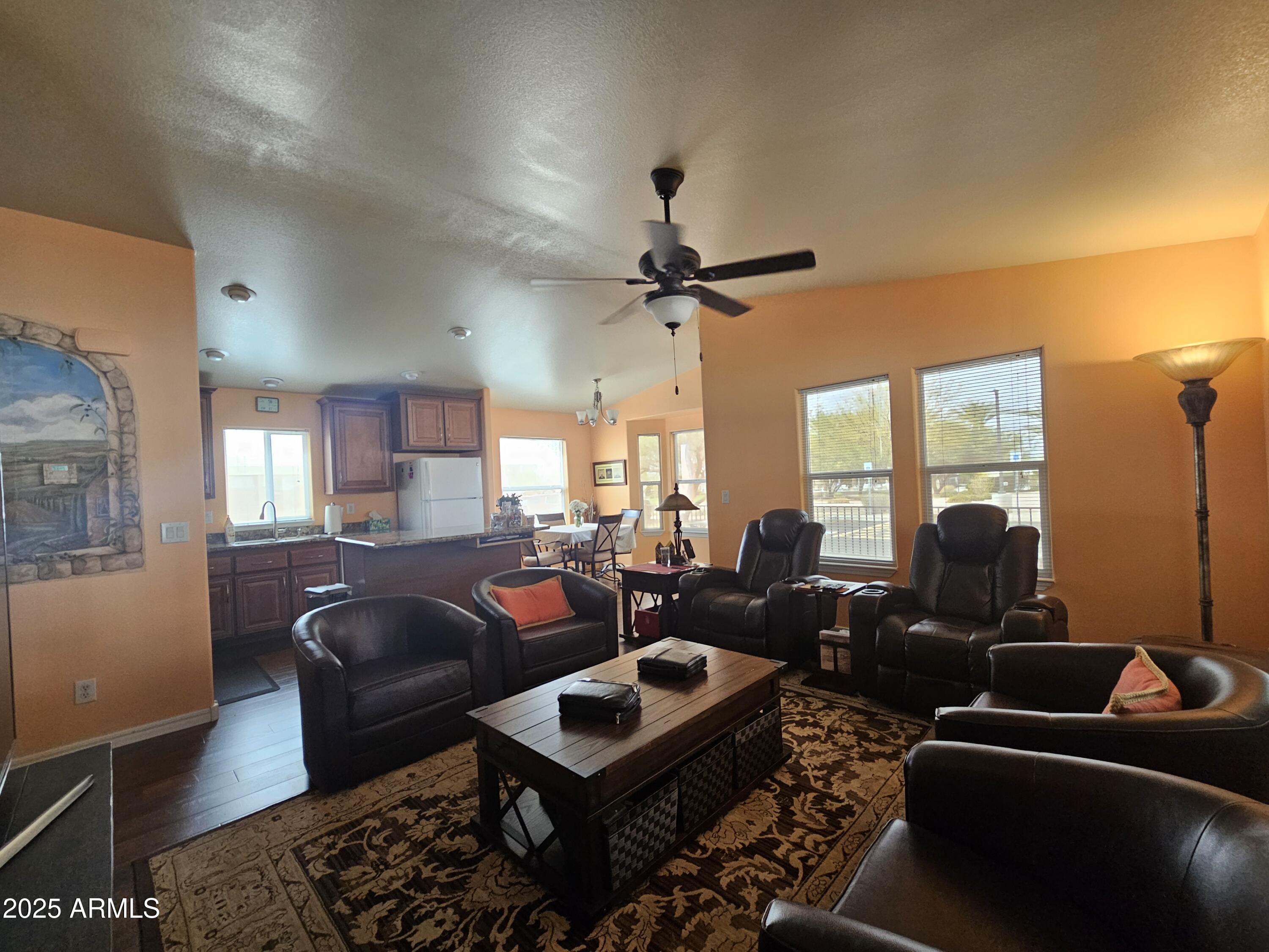 650 North Hawes Road, Unit 4326 Mesa, AZ 85207 - Photo 2 of 48 a living room with furniture a ceiling fan and a large window