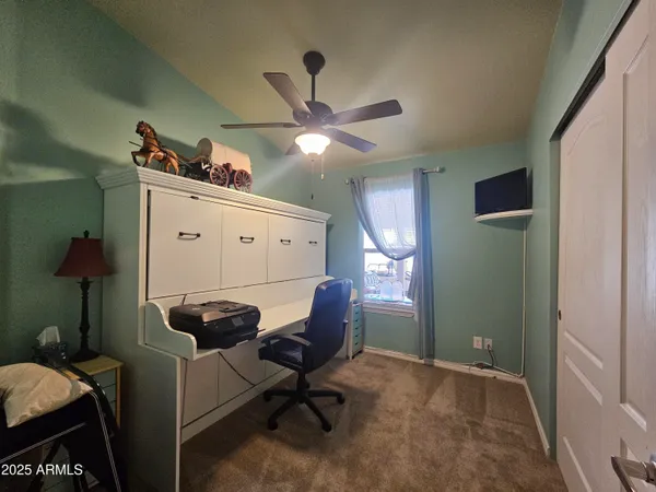 a room with a chair and a refrigerator
