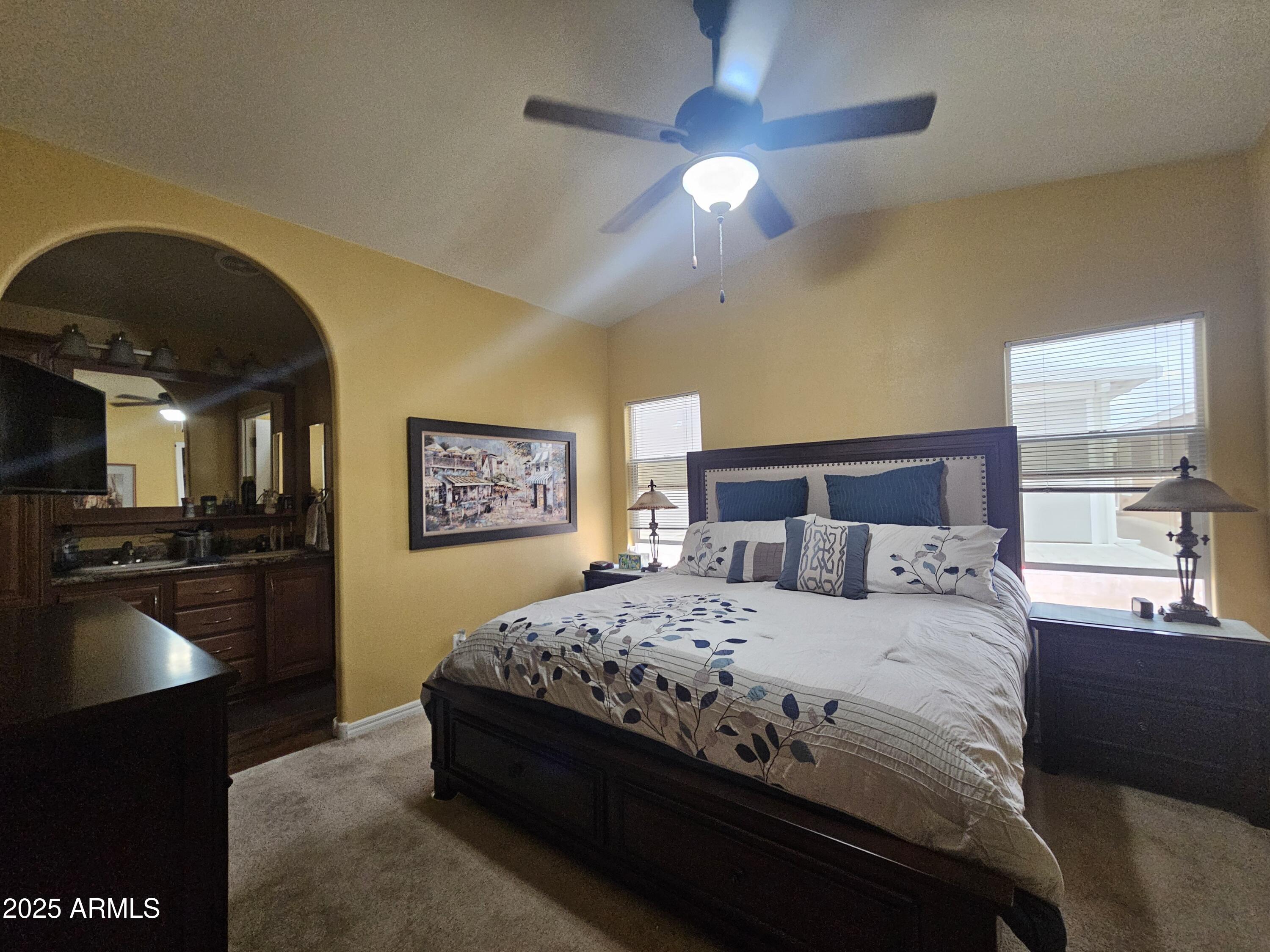 650 North Hawes Road, Unit 4326 Mesa, AZ 85207 - Photo 26 of 48 a bedroom with a bed and a chandelier