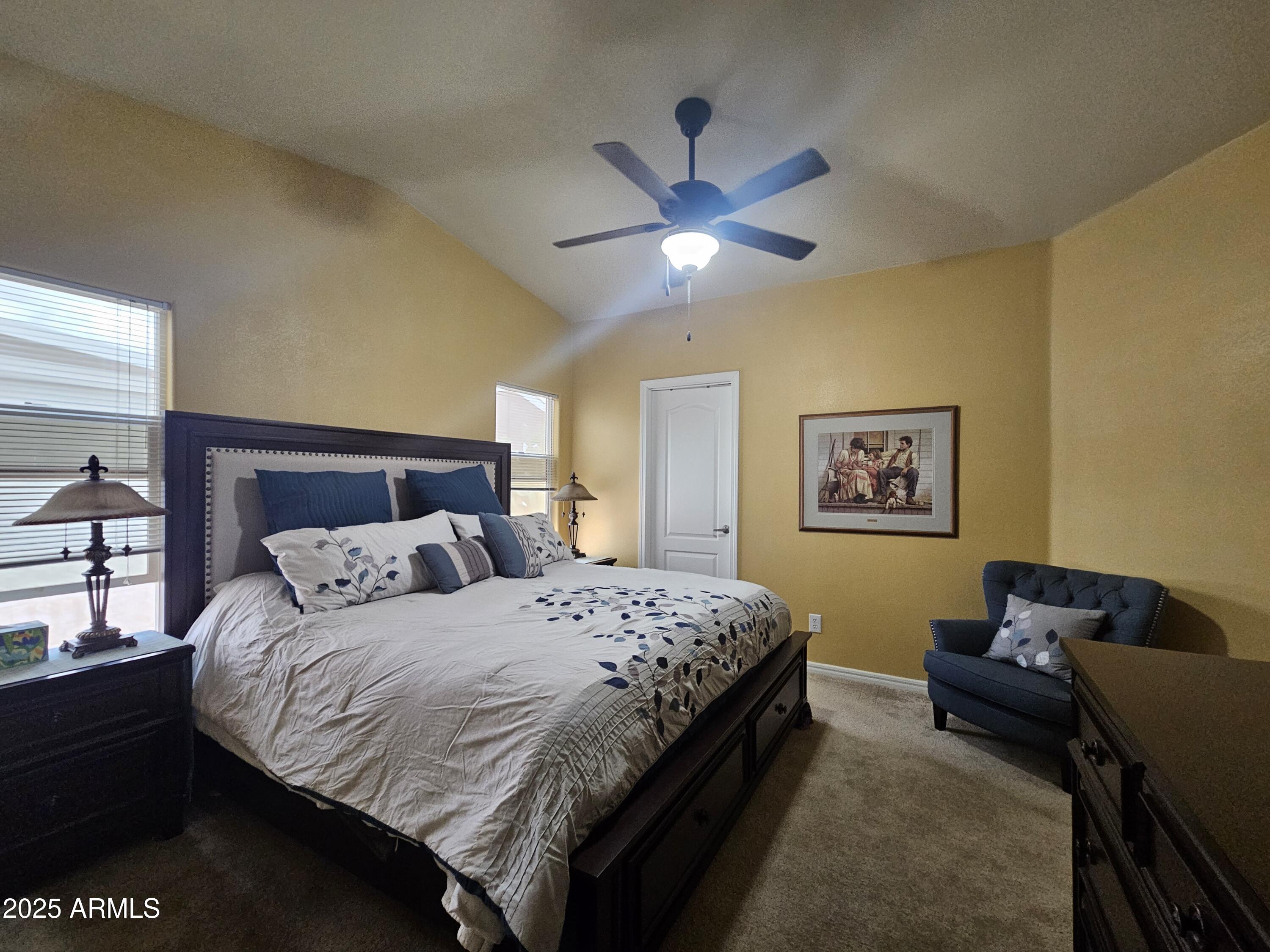 650 North Hawes Road, Unit 4326 Mesa, AZ 85207 - Photo 27 of 48 a bedroom with a bed and a chandelier