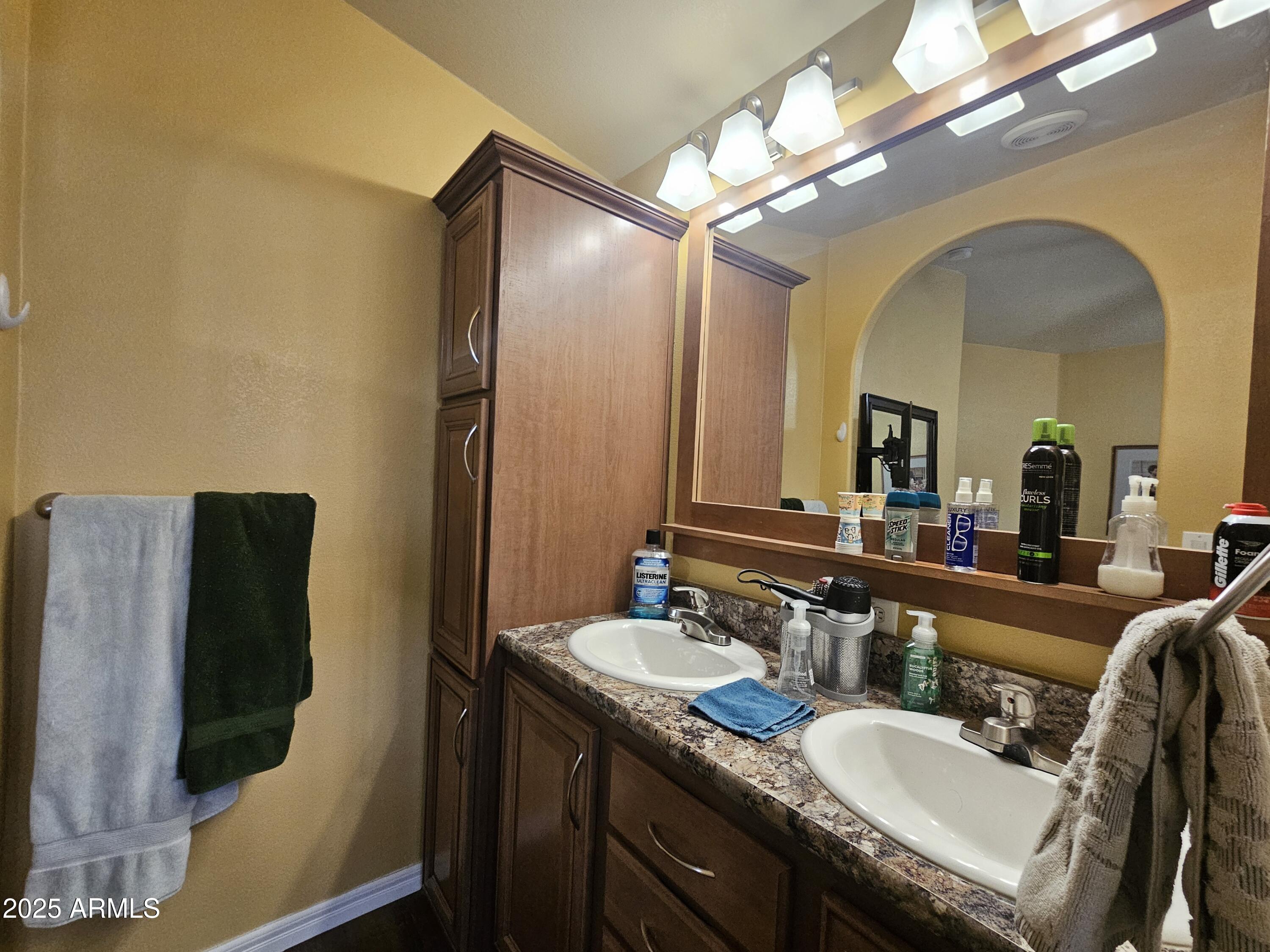 650 North Hawes Road, Unit 4326 Mesa, AZ 85207 - Photo 28 of 48 a bathroom with a granite countertop sink a mirror and a shower