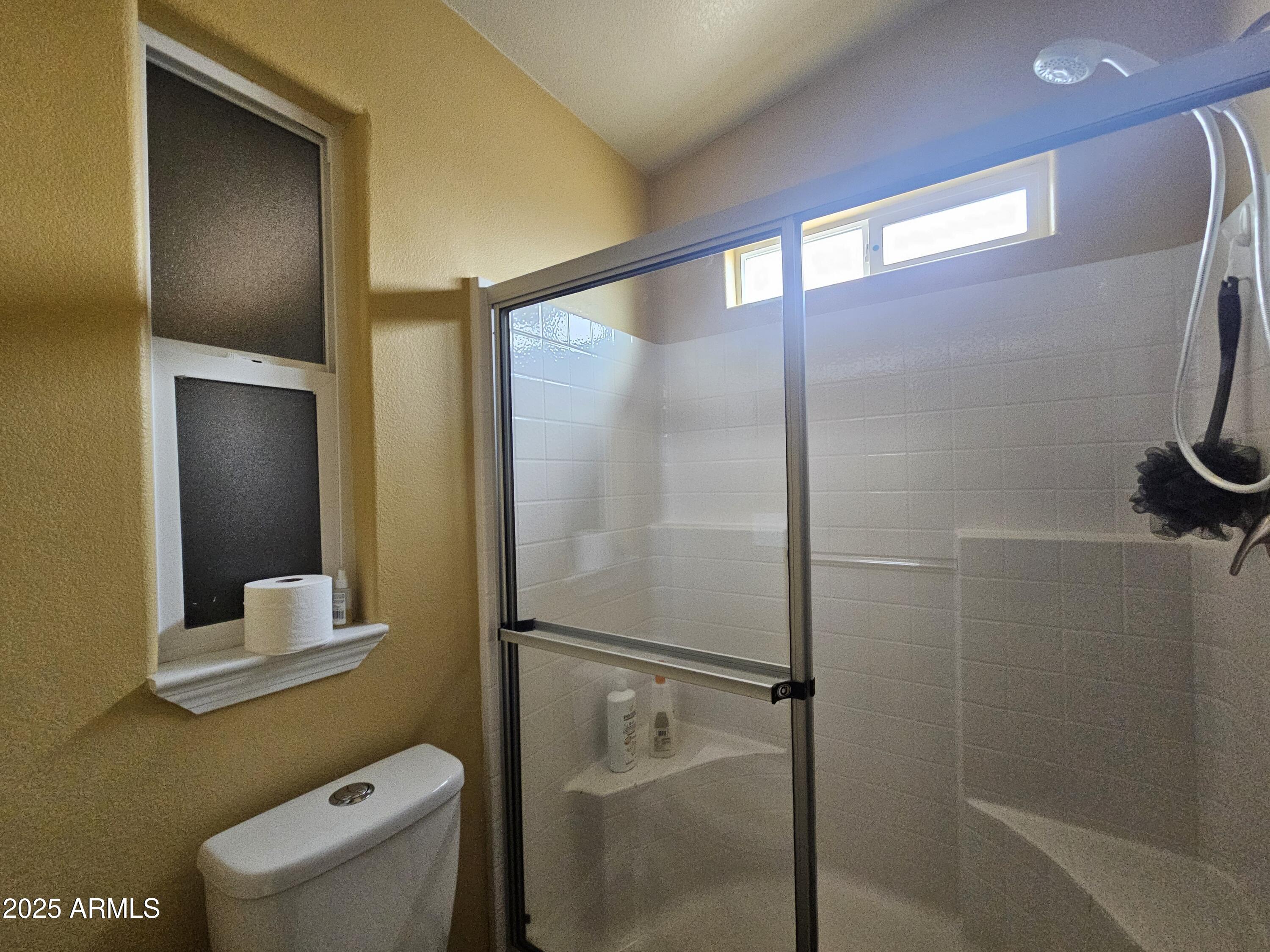 650 North Hawes Road, Unit 4326 Mesa, AZ 85207 - Photo 29 of 48 a bathroom with a shower and a toilet