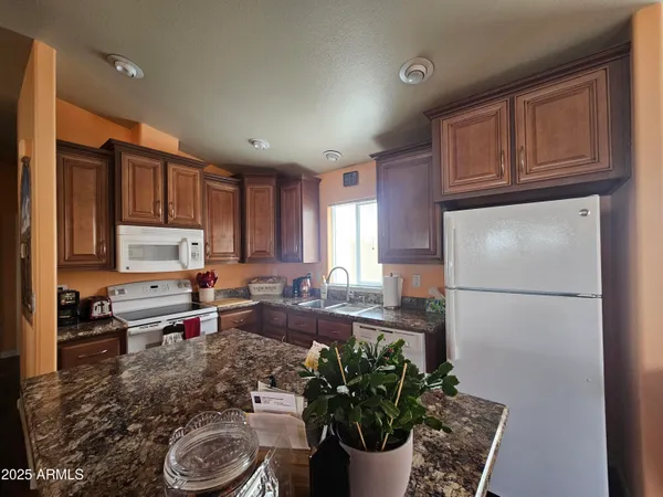 a kitchen with sink refrigerator and microwave