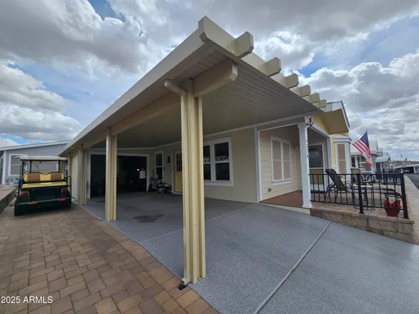 a view of a house with backyard patio and swimming pool