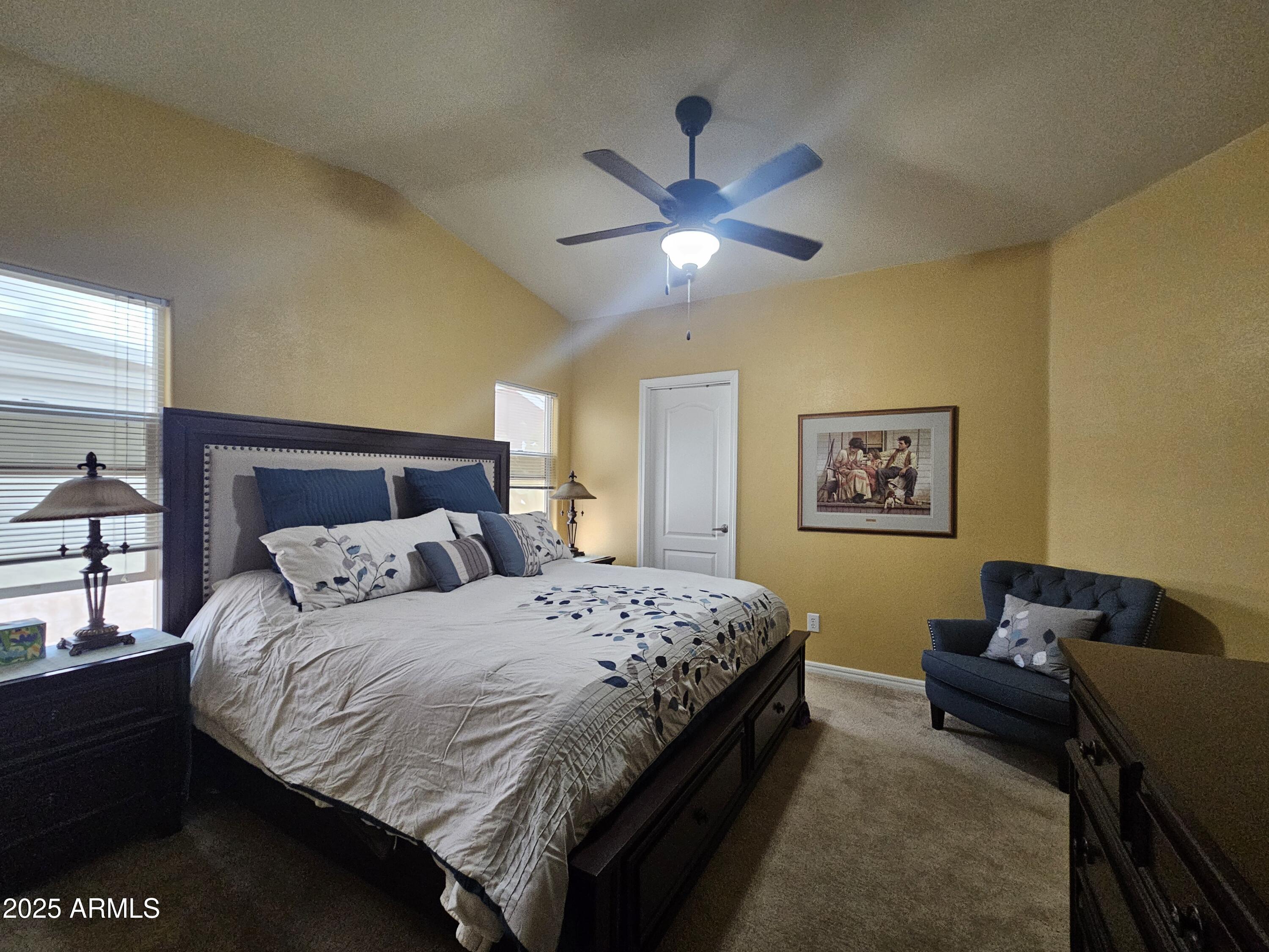 650 North Hawes Road, Unit 4326 Mesa, AZ 85207 - Photo 5 of 48 a bedroom with a bed and a chandelier