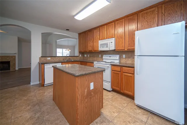 a kitchen with a sink a stove and refrigerator
