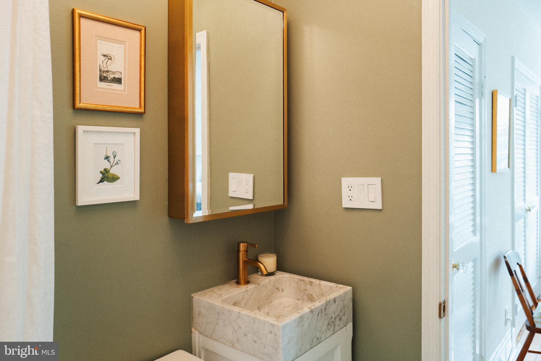 708 9th Street Southeast Washington, DC 20003 - Photo 22 of 31 a bathroom with a sink and a mirror