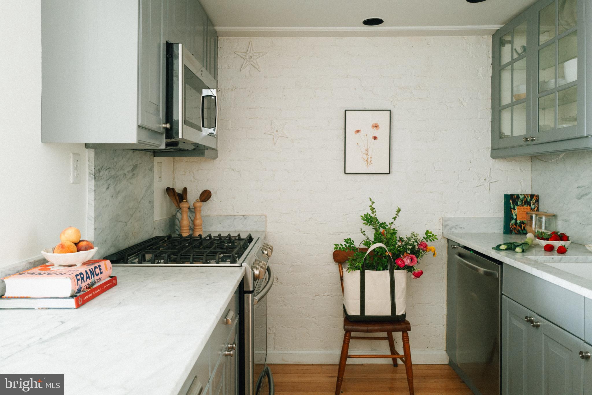 708 9th Street Southeast Washington, DC 20003 - Photo 7 of 31 a white kitchen with a potted plant