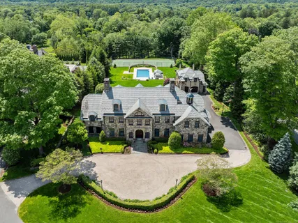 an aerial view of a house with a swimming pool outdoor seating yard and mountain view