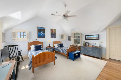 a bedroom with furniture and a wooden floor