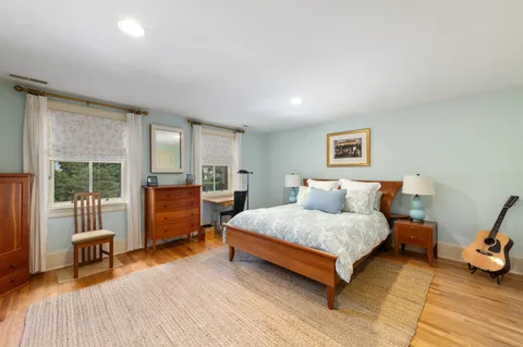 a spacious bedroom with a bed and a table