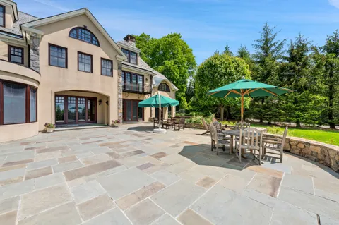 a view of a house with backyard and sitting area