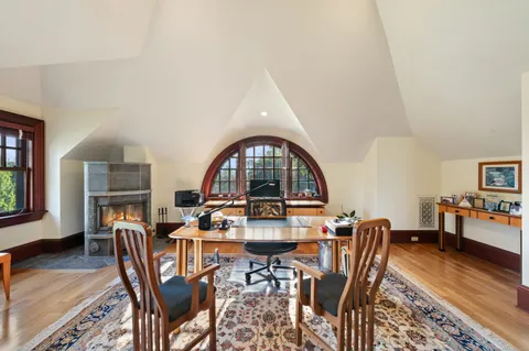 a view of a dining room with furniture a rug and wooden floor