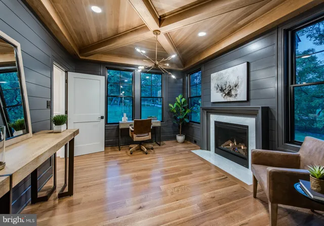 a living room with furniture a fireplace and a table