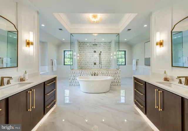a bathroom with a double vanity sink a mirror and a bathtub