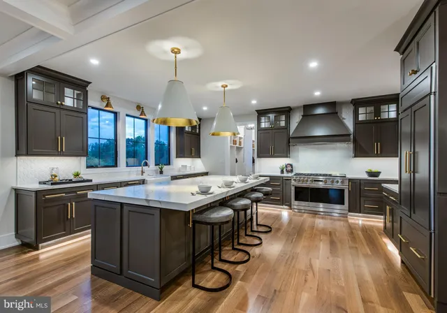 a kitchen with stainless steel appliances a stove a sink and a refrigerator