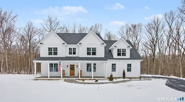 a view of house with yard and street