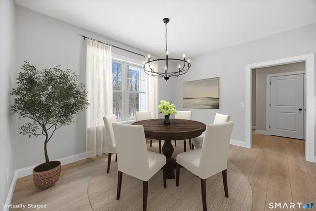 a view of a dining room with furniture and wooden floor