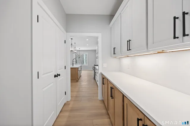 a view of a kitchen with white cabinets
