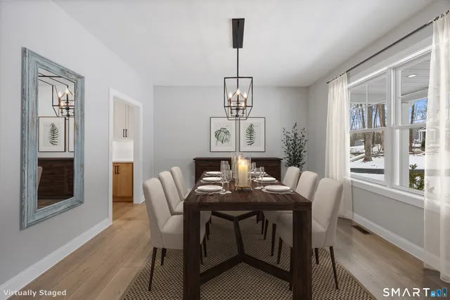 a view of a dining room with furniture window and wooden floor
