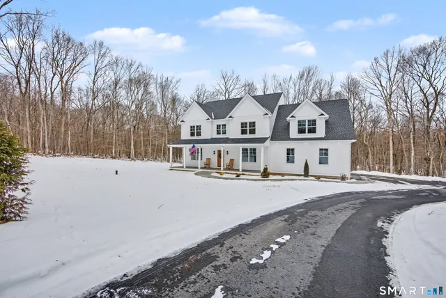 a view of a house with a snow in the yard