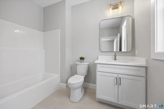 a bathroom with a toilet sink and bathtub