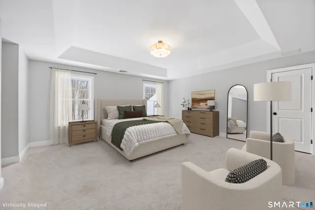 a spacious bedroom with a bed a couch and dresser