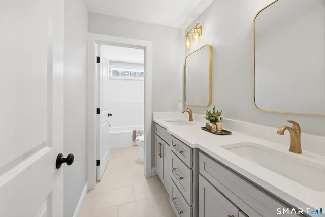 a bathroom with a double vanity sink and a mirror
