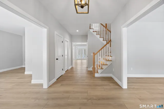 a view of entryway and hall with wooden floor
